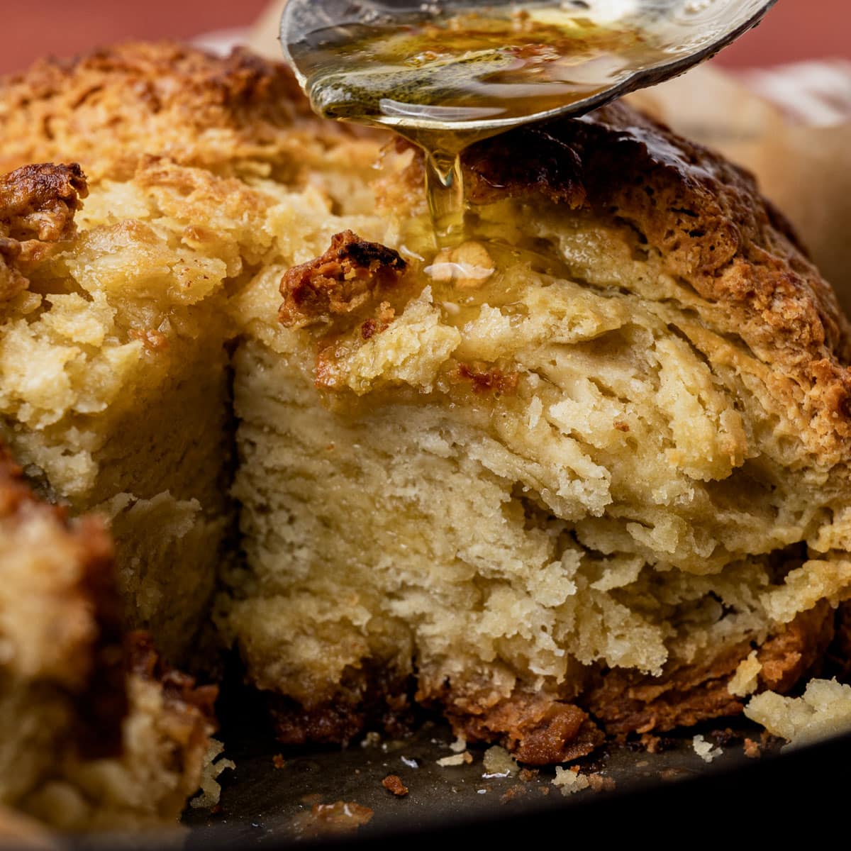 drizzling sage brown butter over a loaf of irish soda bread