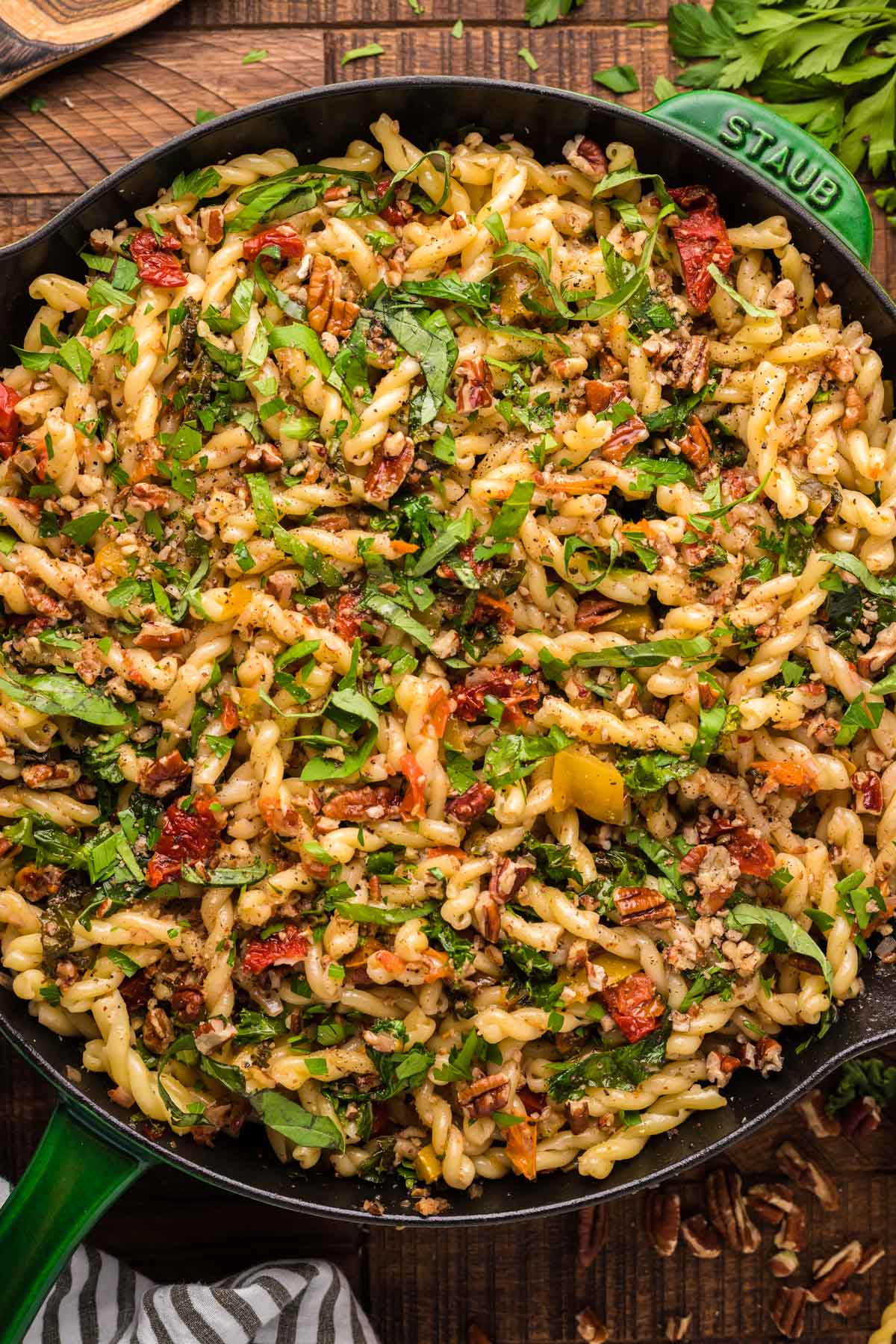 overhead view of vegetarian pecan tomato pasta in a skillet