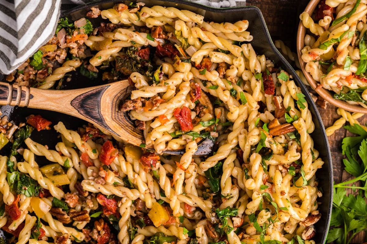 a pasta skillet with a wooden spoon