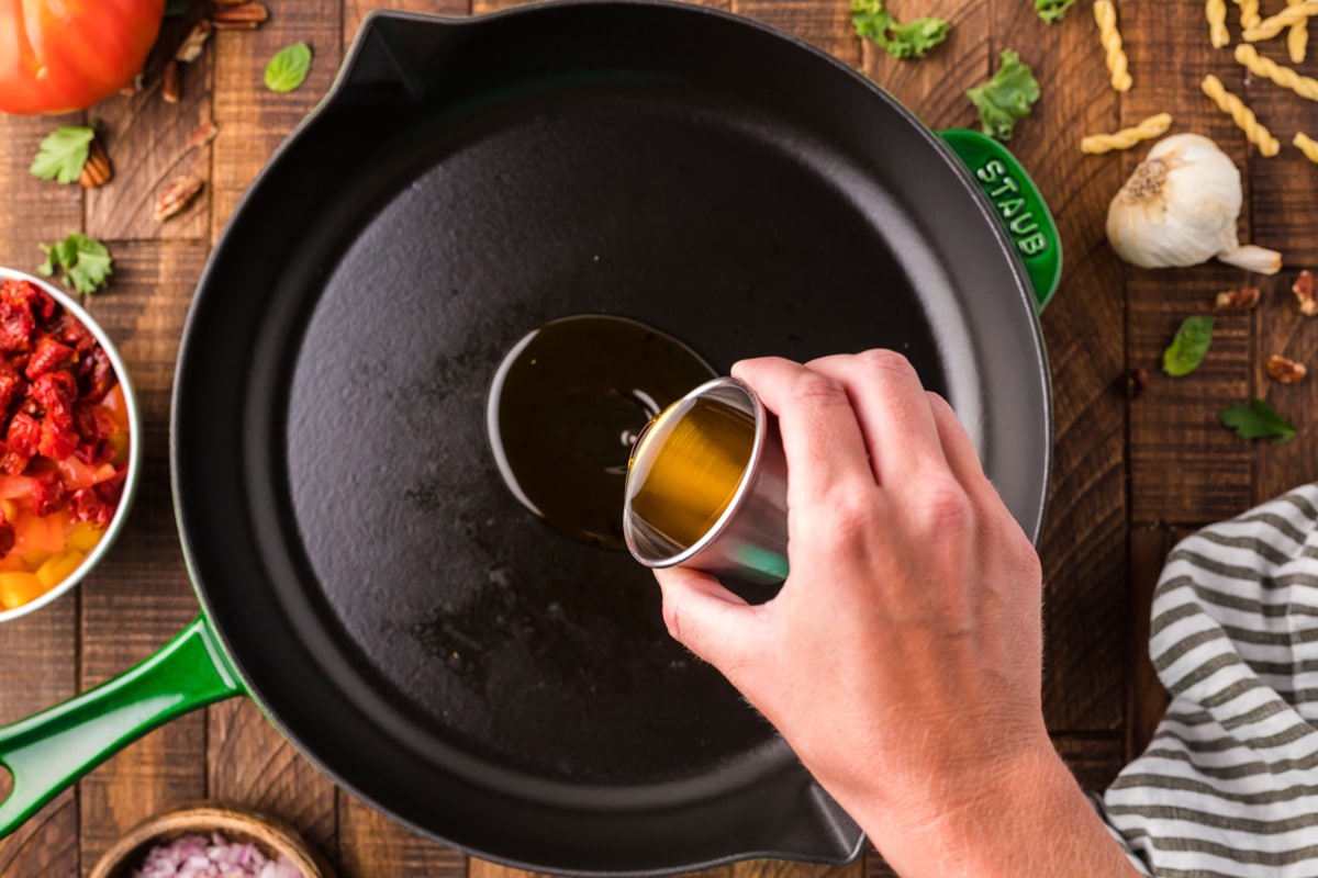 pouring oil into a skillet