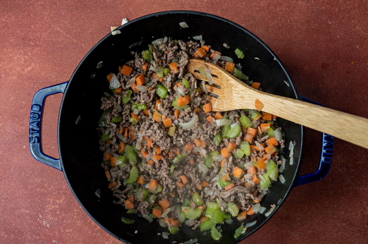 ground beef sautéed with veggies in a pan