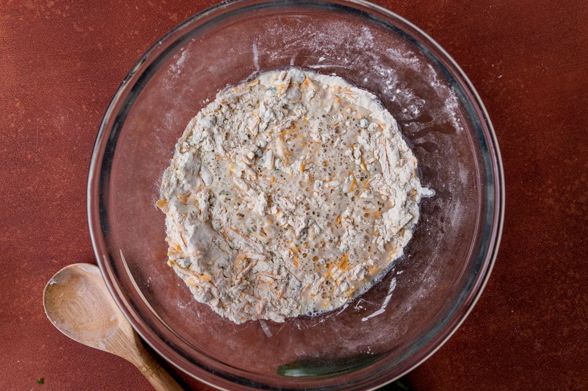 water, flour and cheese in a mixing bowl
