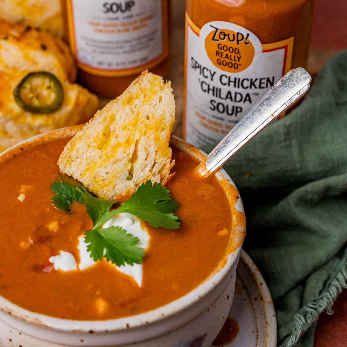 a bowl of soup with cheese bread in it