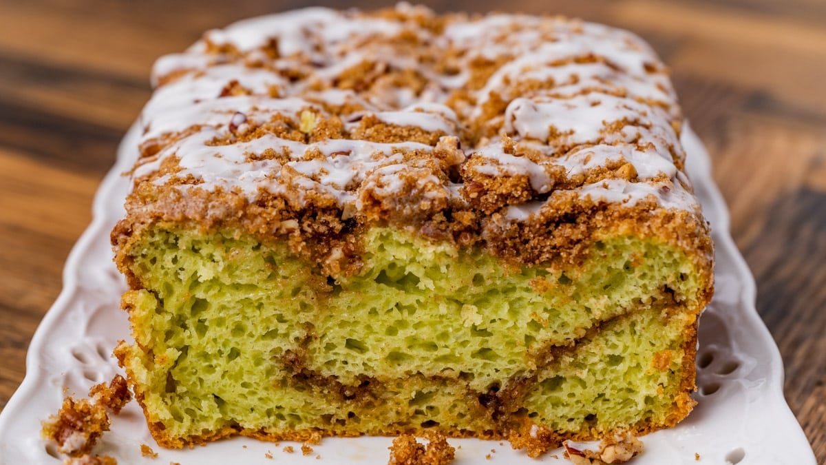 half of a loaf of pistachio bread on a table