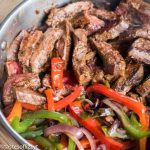 steak veggies and fajitas in a skillet