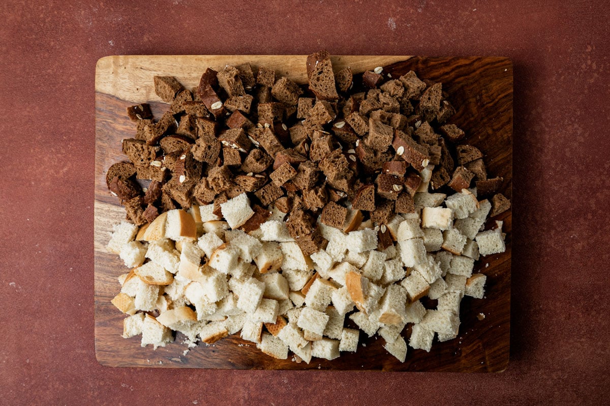 rye and white bread cubes sitting on a cutting board