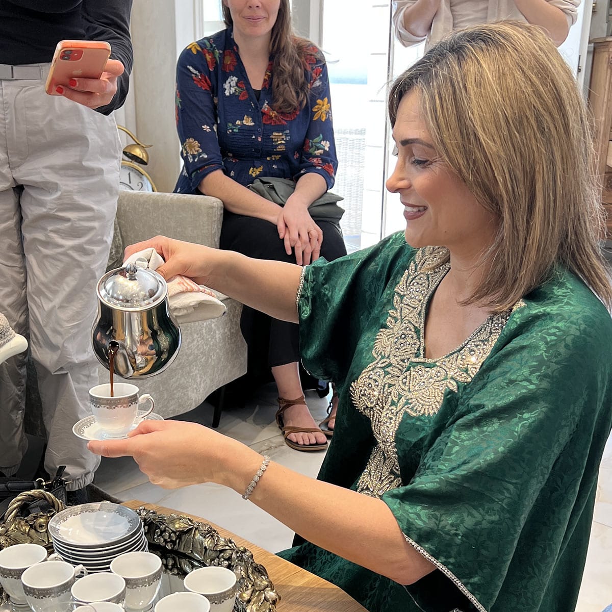 doris pouring a cup of coffee into a cup