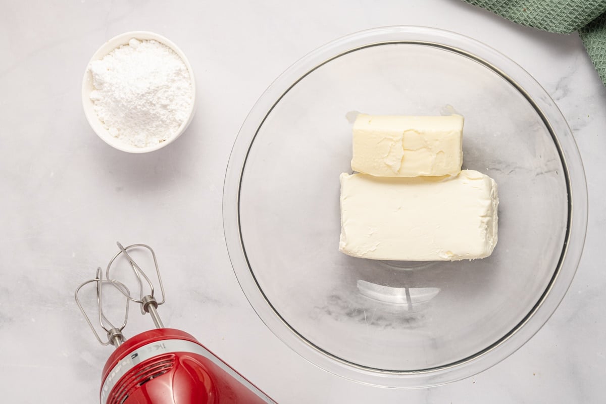 cream cheese and butter in a glass mixing bowl