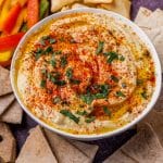 a bowl of hummus with parsley, cumin and paprika