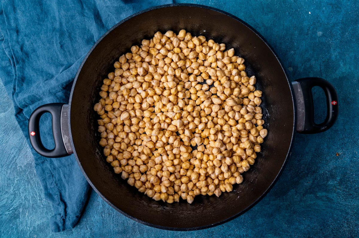 garbanzo beans in a saucepan with baking soda on them