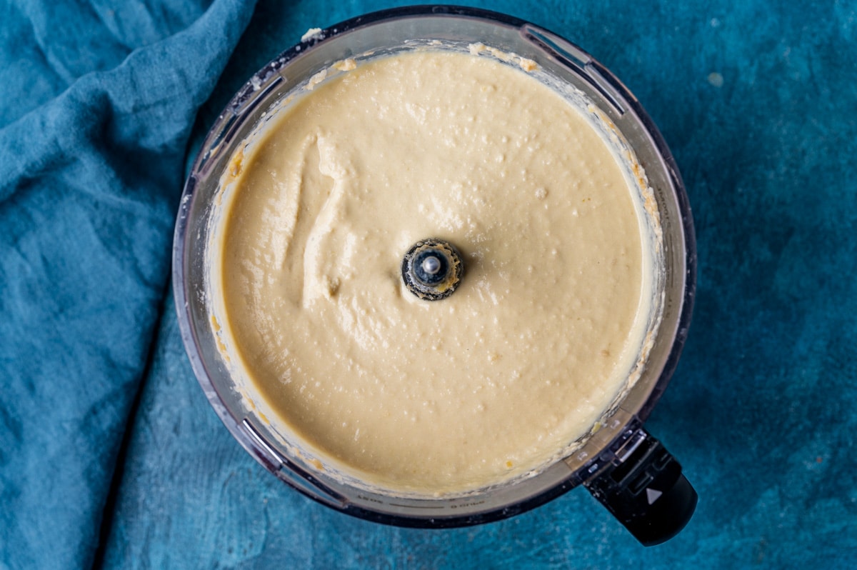 creamy hummus in a food processor bowl