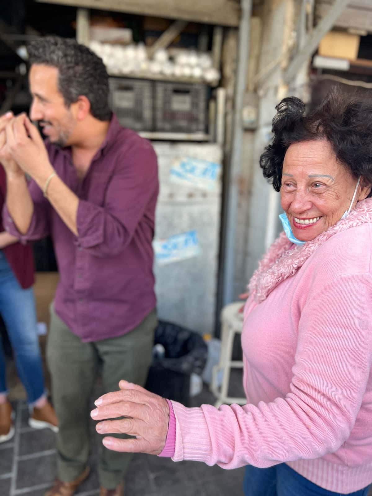 an elderly woman dancing in the street of Israel
