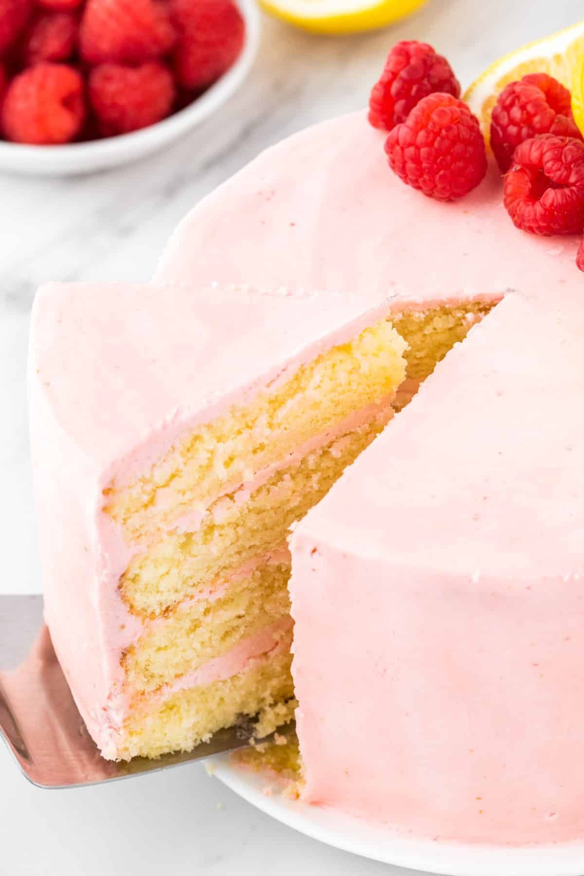 a slice of raspberry lemon cake on a spatula