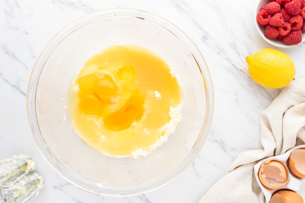 eggs over creamed butter in a mixing bowl