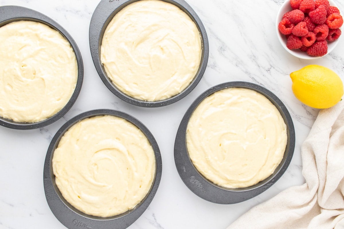 4 unbaked lemon cakes on a table