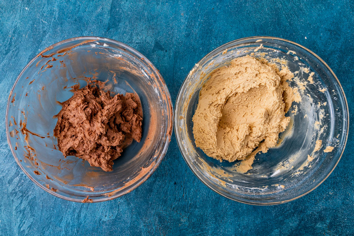 chocolate frosting and peanut butter frosting in bowls on a table