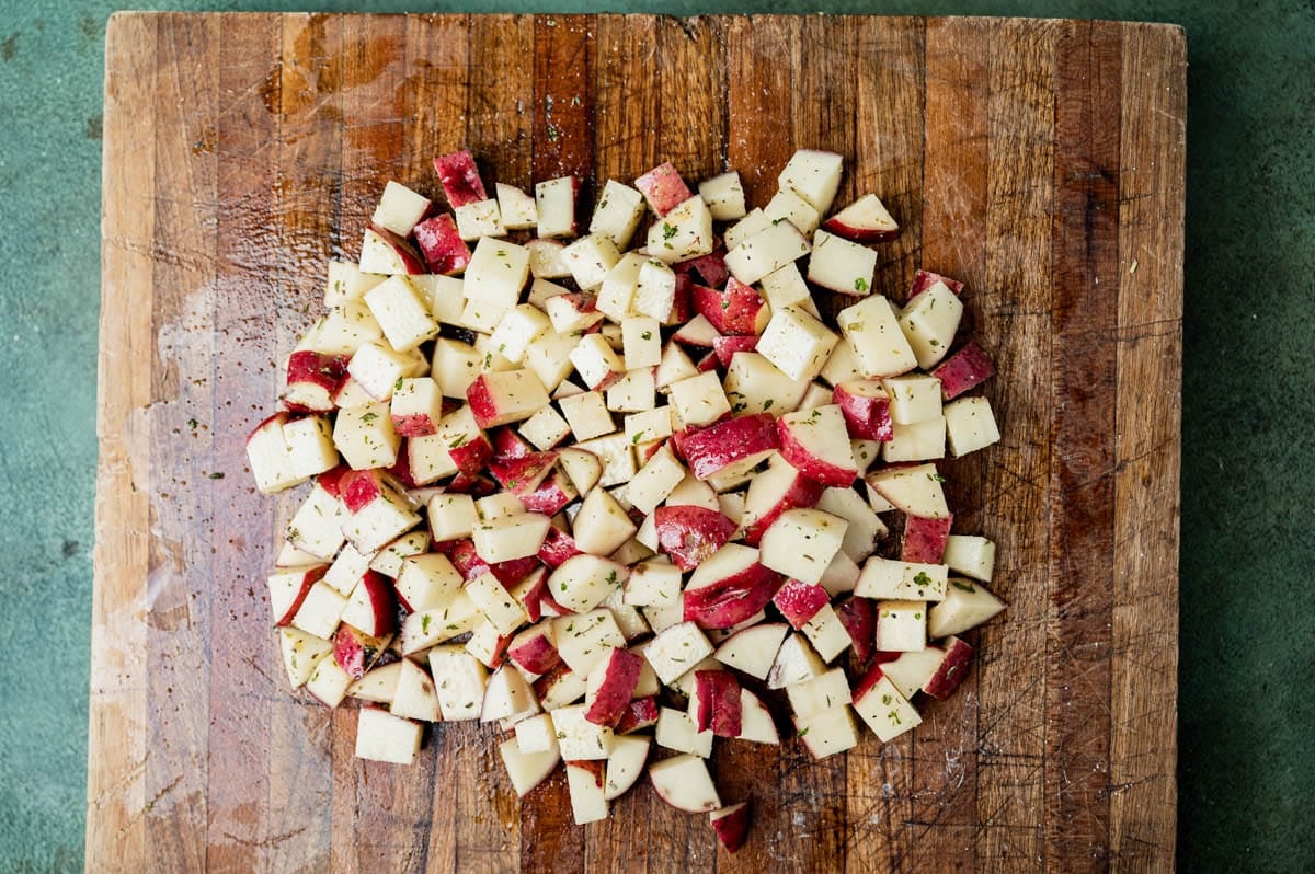 diced potatoes on a cutting board with seasonings