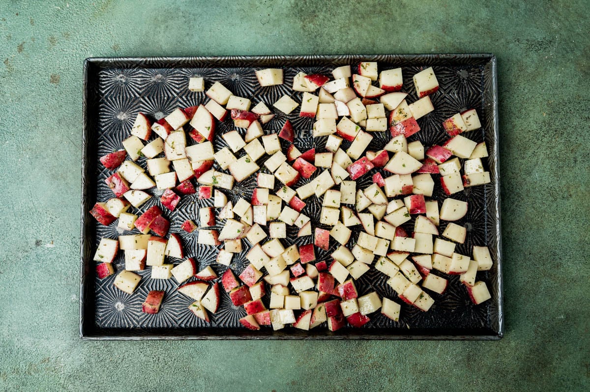 diced potatoes on a pan with seasonings