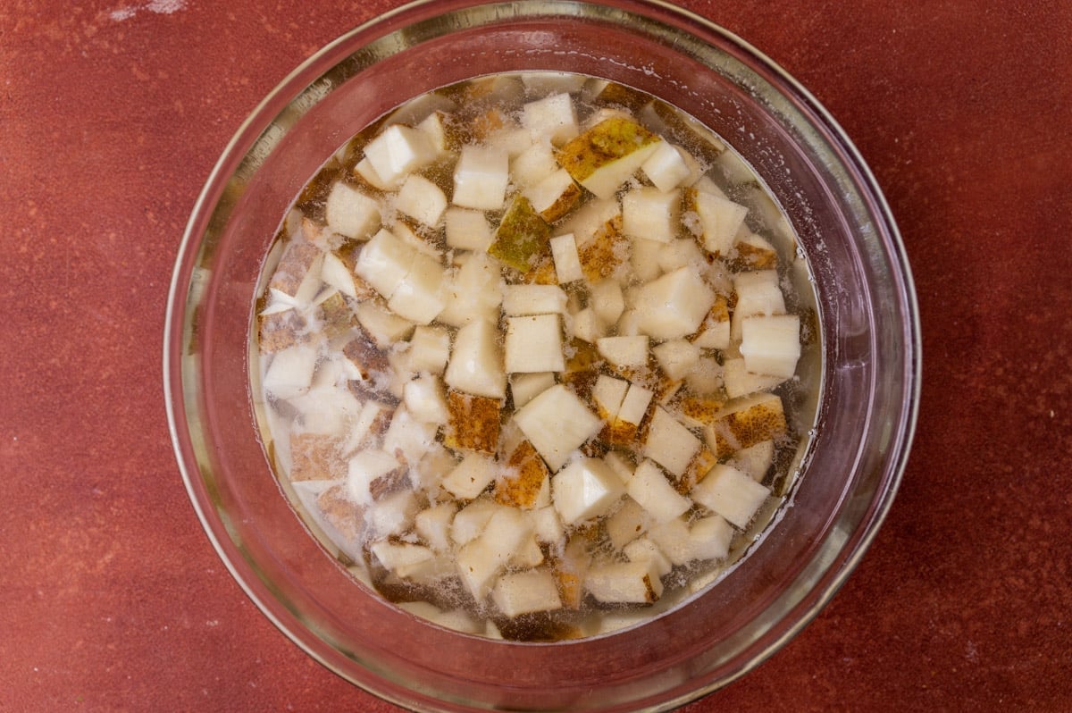 cubed potatoes in water in a glass bowl