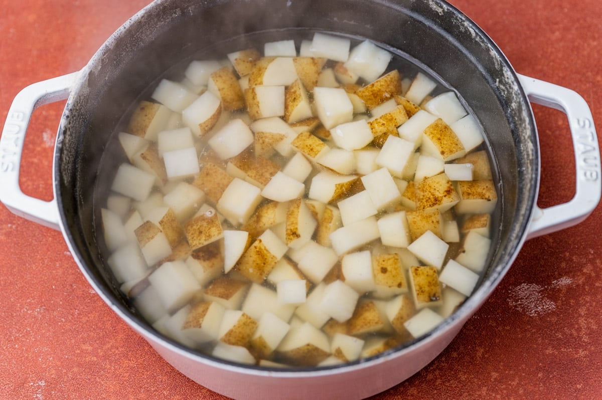 cubed potatoes boiling in a pan of water