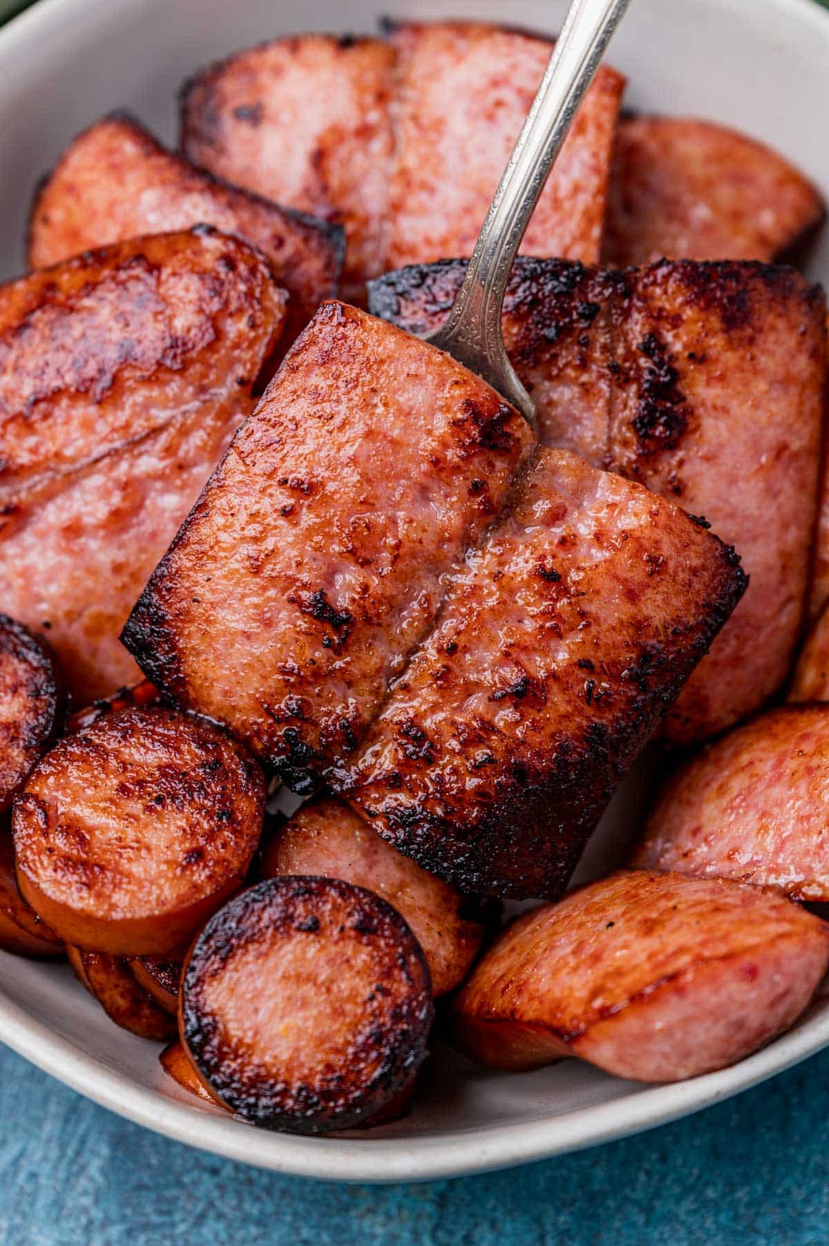 kielbasa in a bowl with a fork