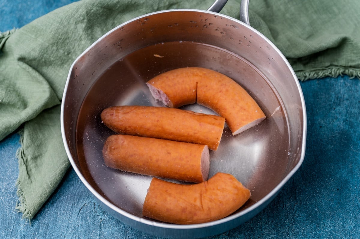 kielbasa in a sauce pan with water