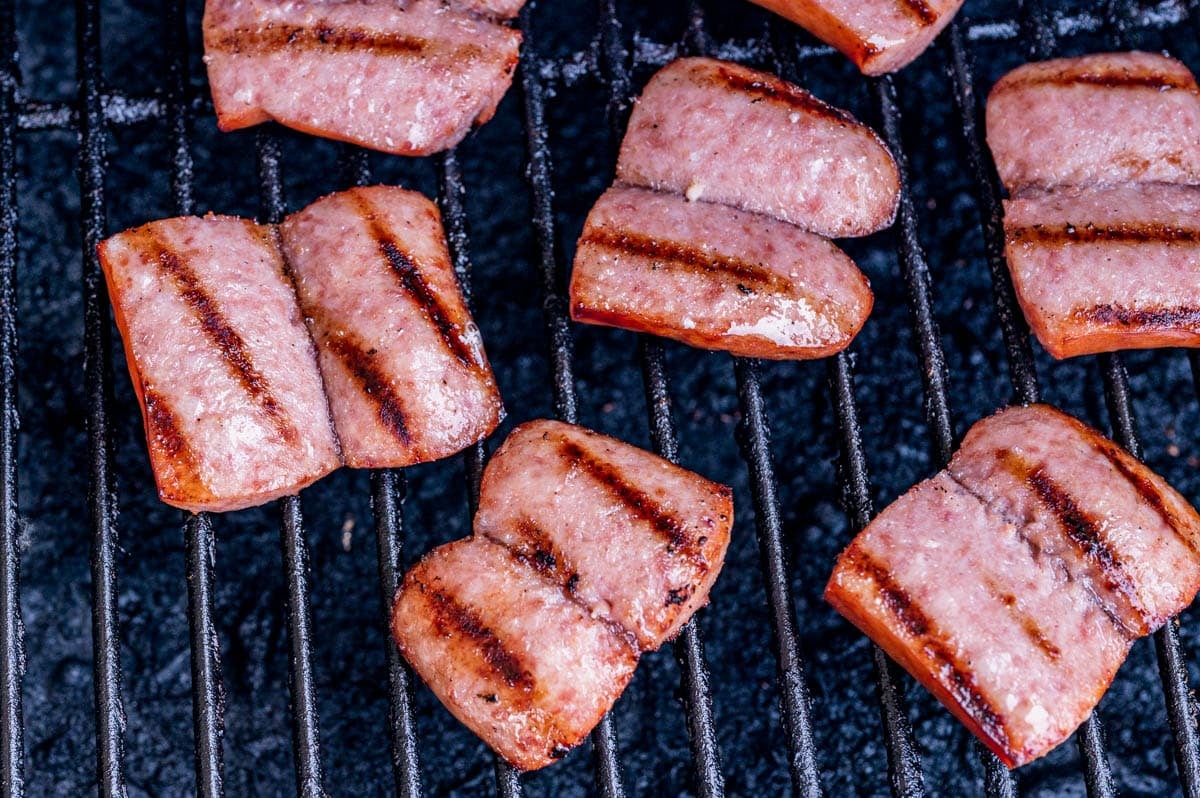 pieces of kielbasa on a grill