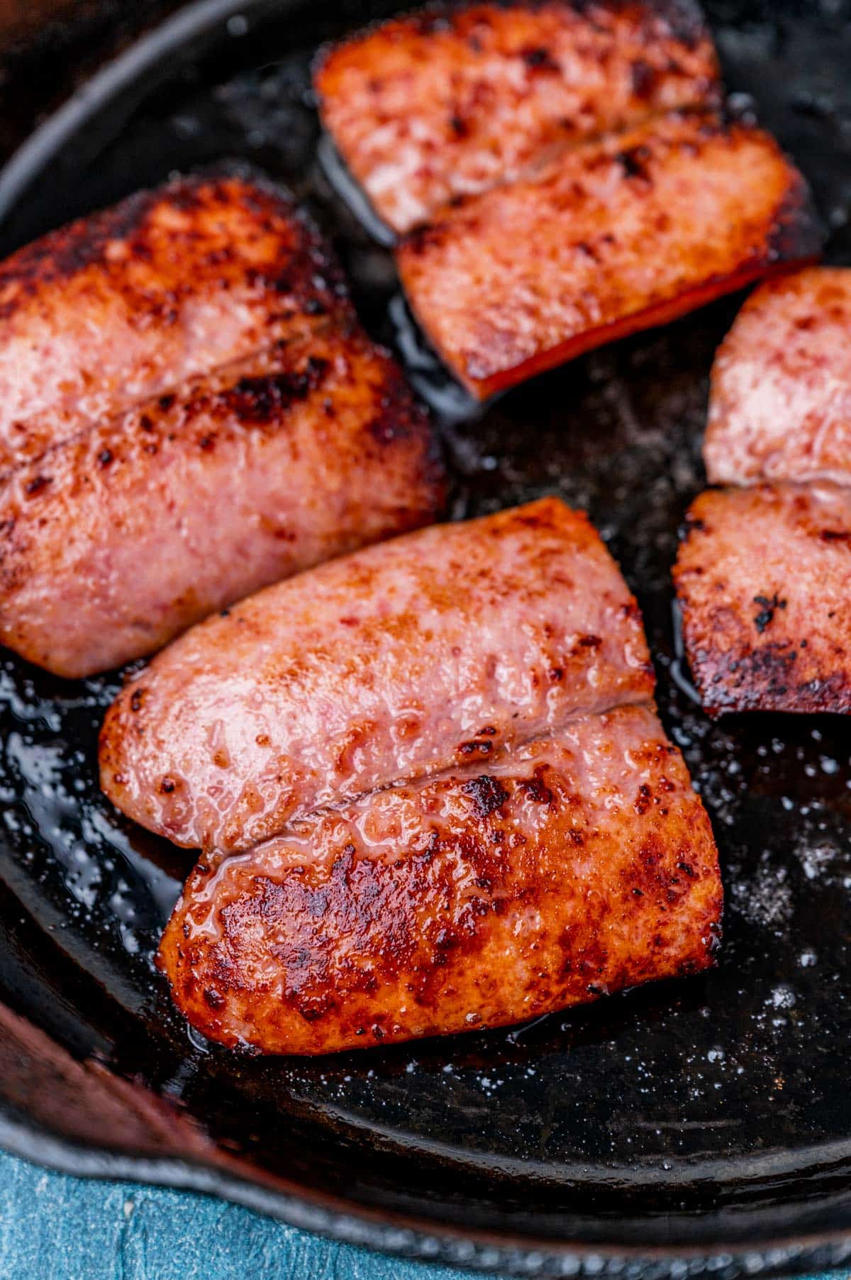 kielbasa pieces in a cast iron skillet