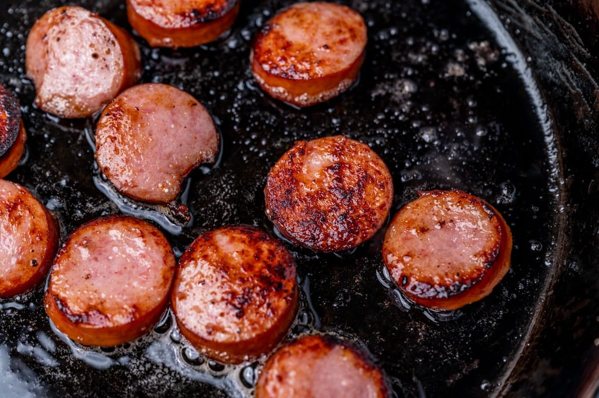 kielbasa rounds in a cast iron skillet