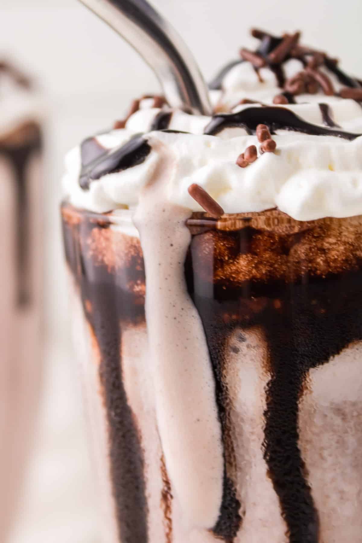 closeup of a dripping chocolate milkshake