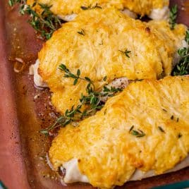 closeup of mayo chicken with thyme in a glass pan