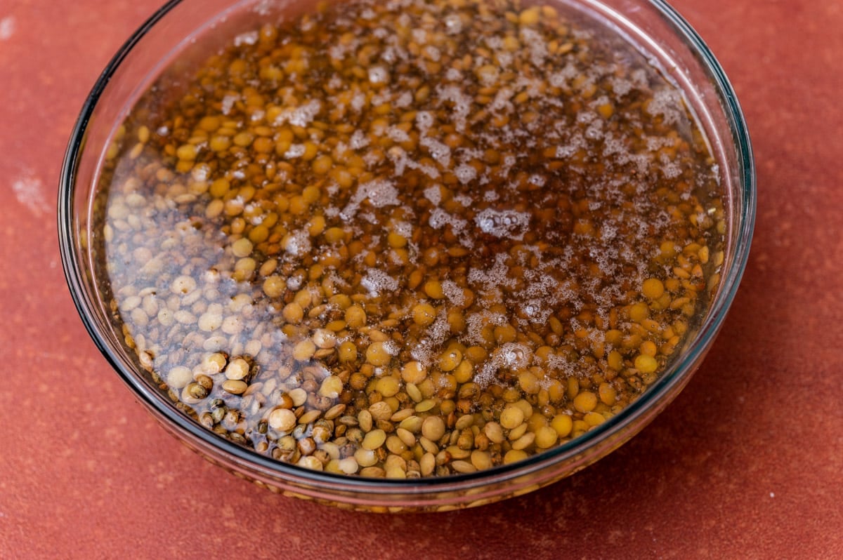 lentils soaking in water in a glass bowl