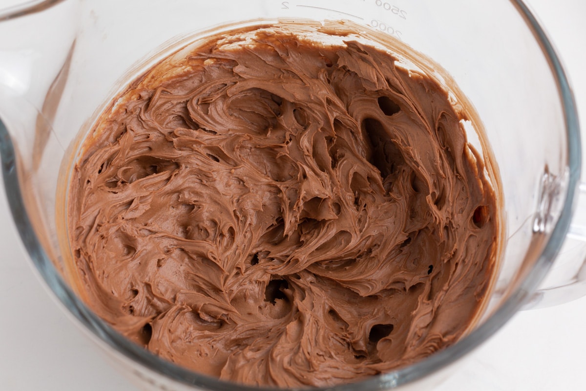 chocolate frosting in a glass bowl