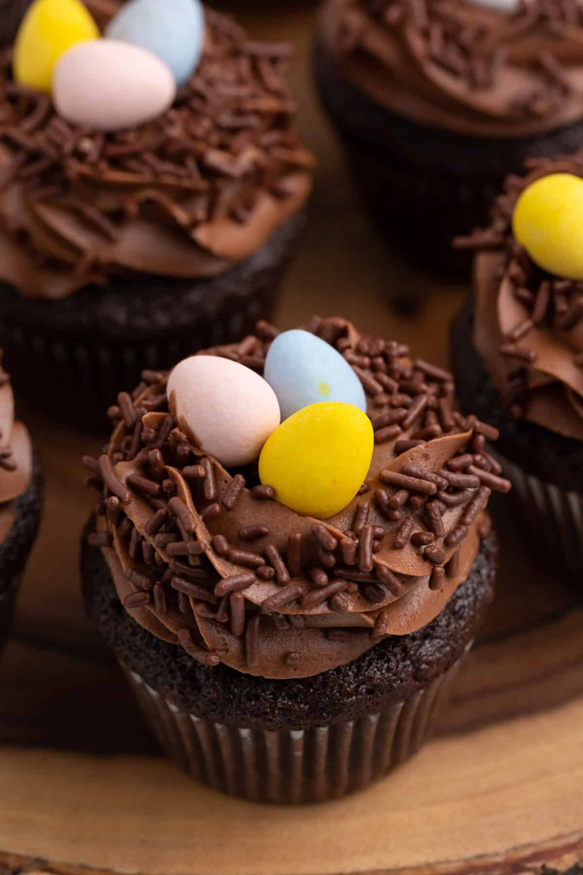 double chocolate robin's nest cupcakes on a wood platter