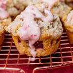 a strawberry muffin sitting on a wire rack