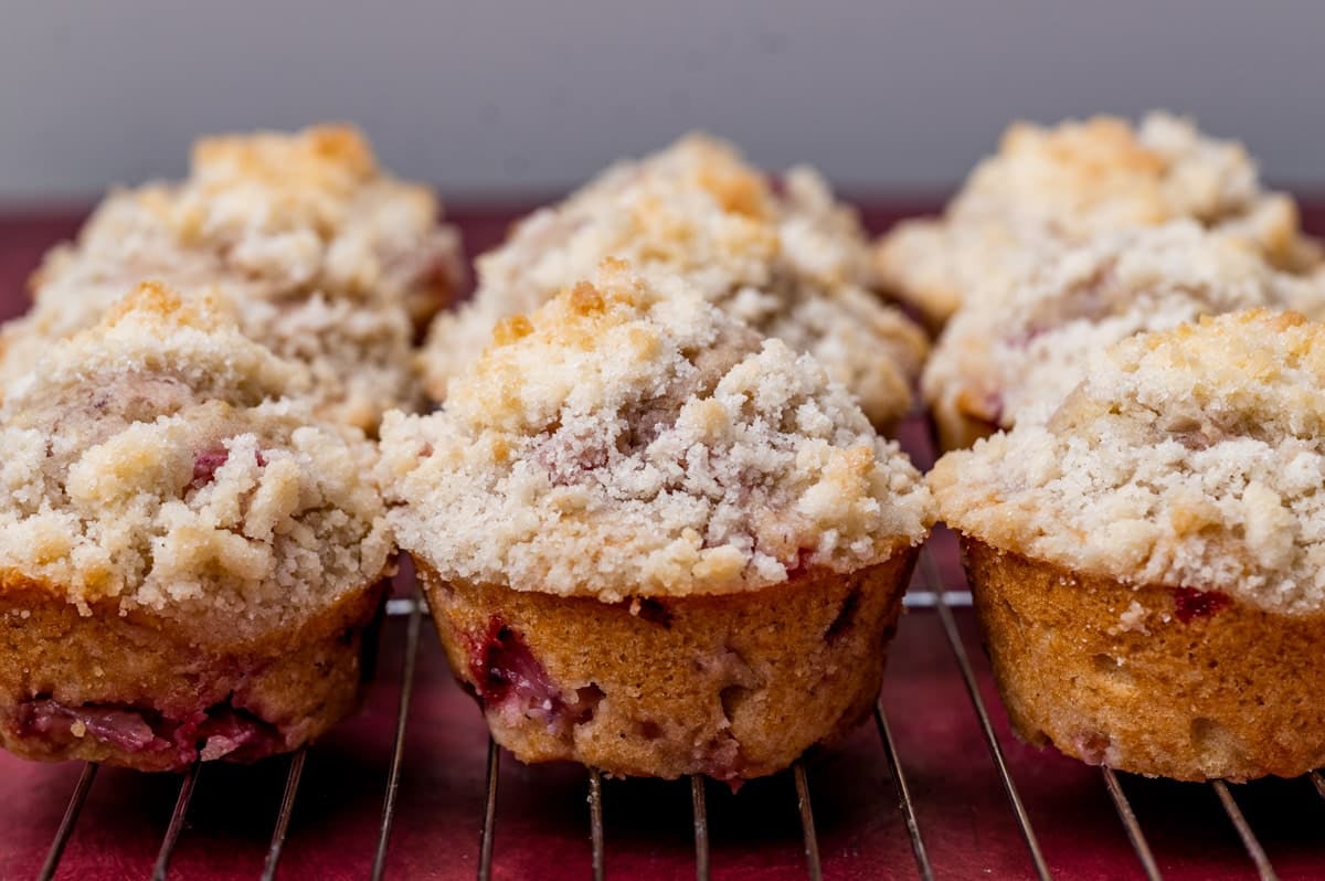 strawberry muffins with crumb topping on a cooling rack