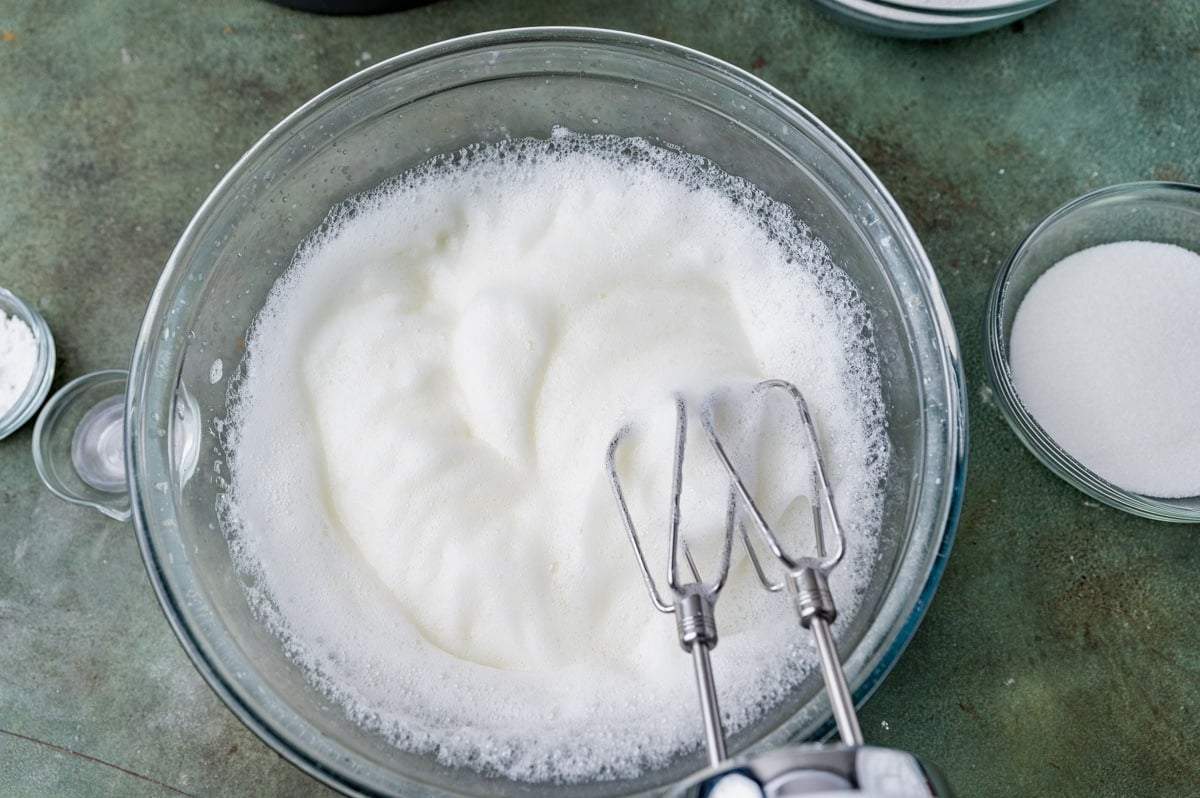 egg whites frothed in a glass bowl