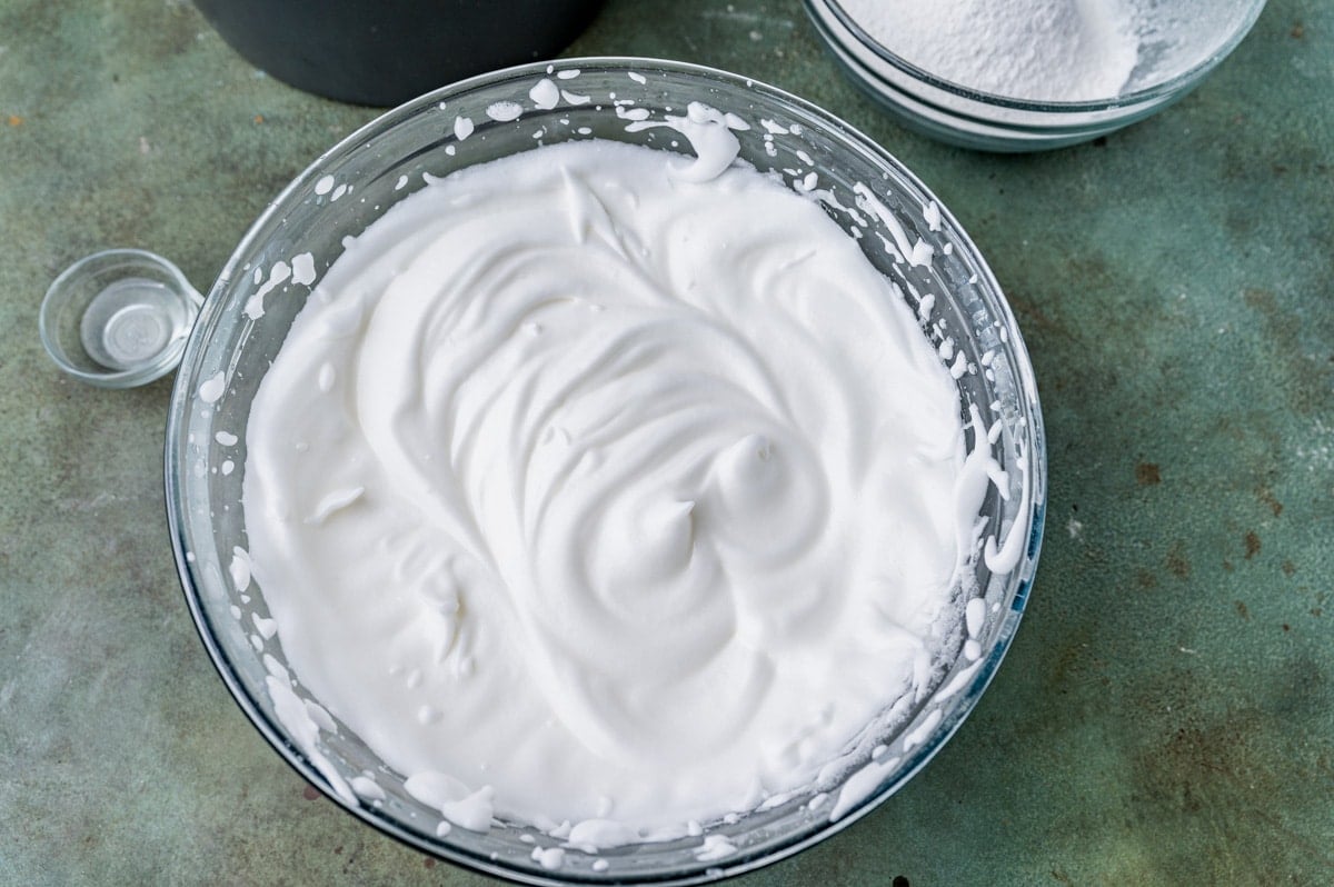 whipped egg whites in a glass bowl