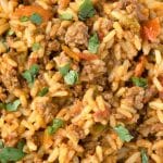 closeup of spanish rice with ground beef and fresh parsley on top