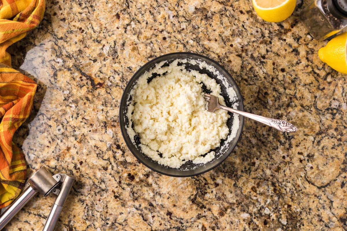 parmesan, pasta water and lemon juice in a bowl