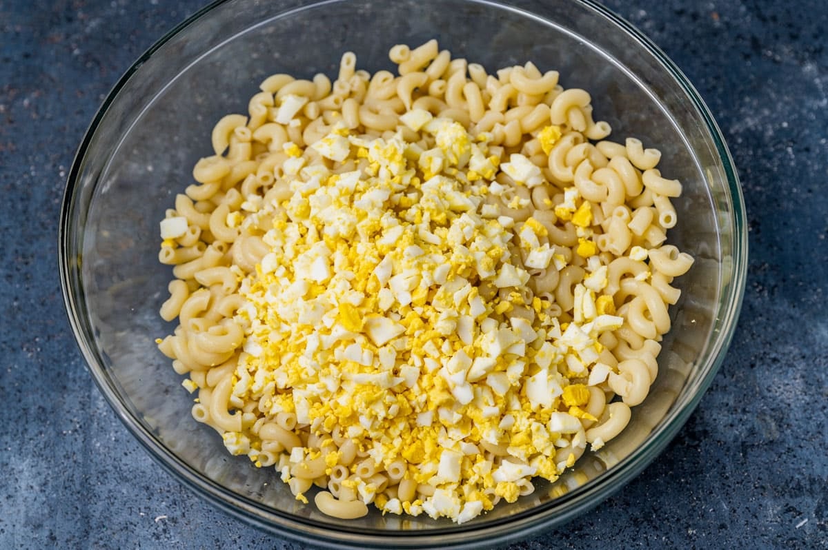 elbow macaroni and hard boiled eggs in a bowl