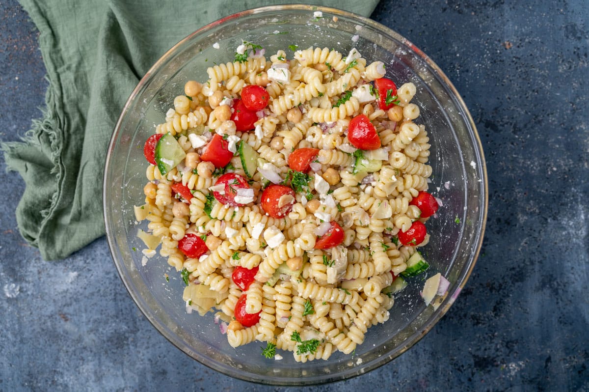 chickpea pasta salad mixed in a glass bowl
