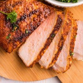 a sliced pork chop on a cutting board