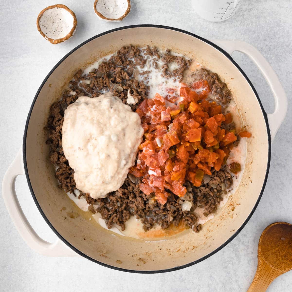 ground beef, cream of mushroom soup and tomatoes in a skillet