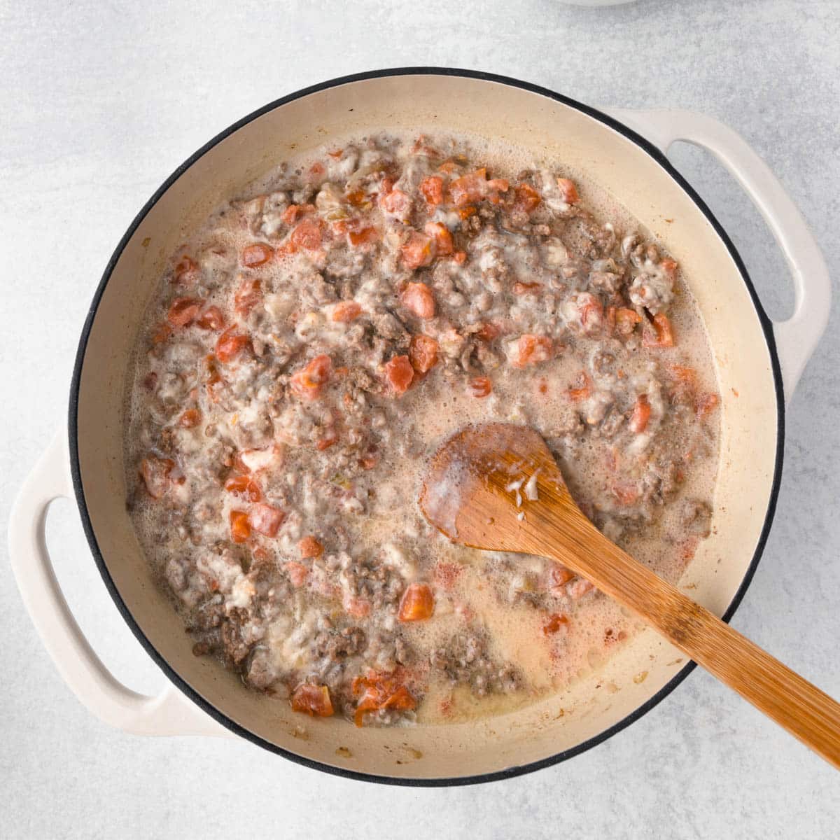 ground beef, tomatoes and milk in a skillet
