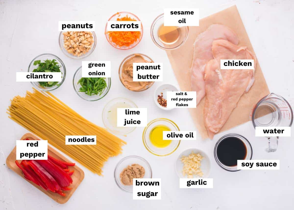 ingredients for peanut noodles with chicken on a table