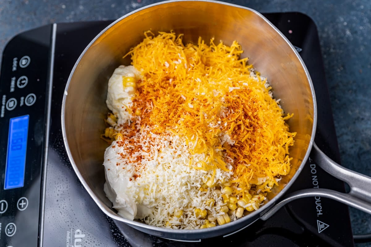 corn, mayo, cheese and tajin in a saucepan