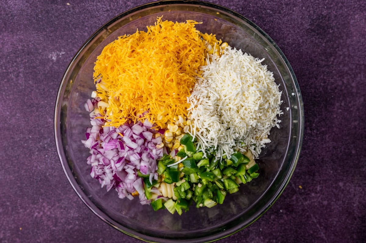 cheddar, cotija, red onion, jalapeño and pasta in a glass bowl