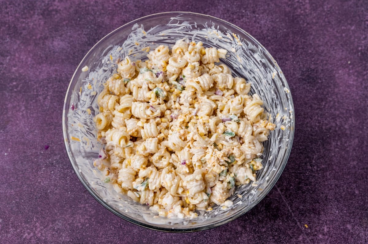 a glass bowl filled with pasta salad