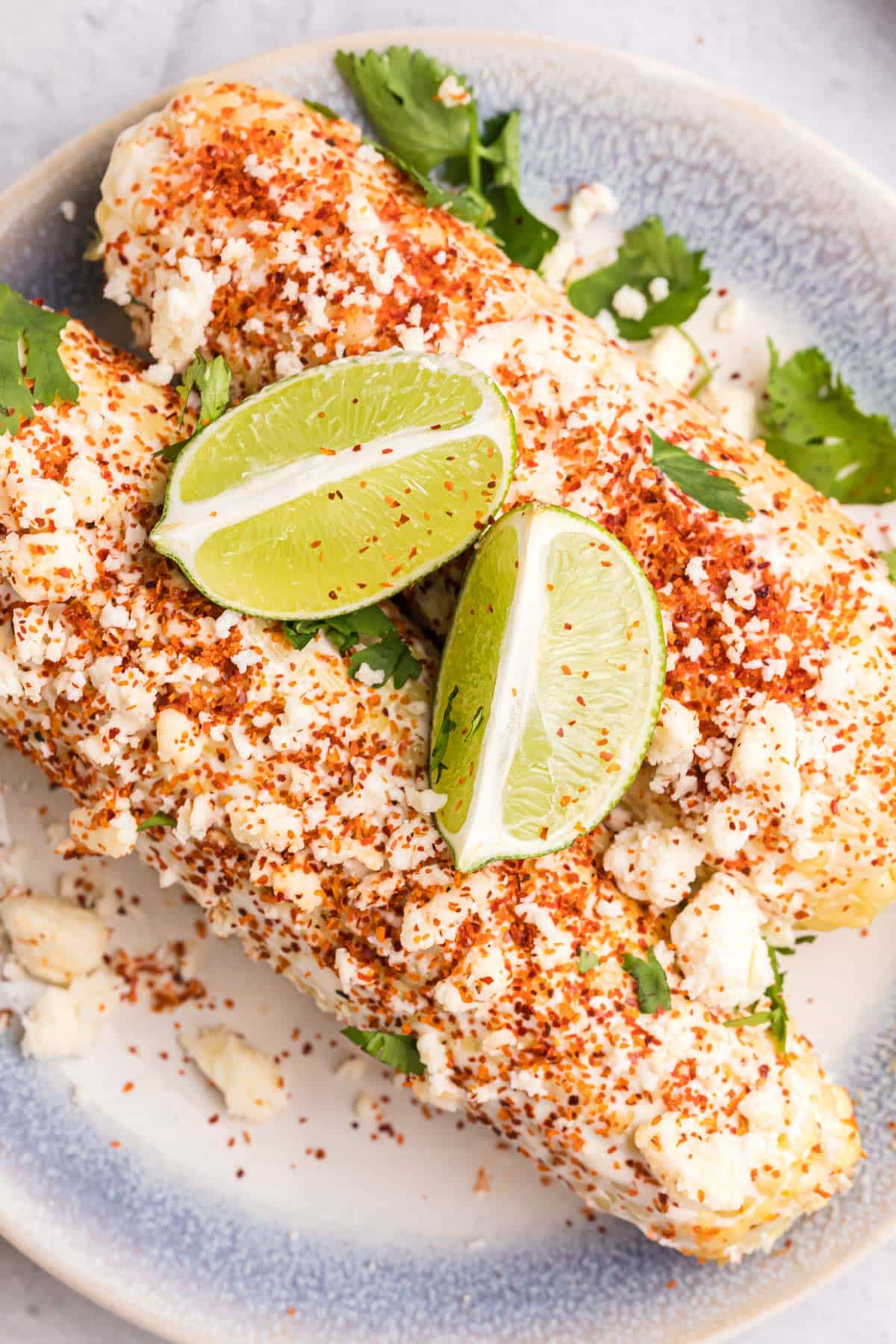 overhead view of mexican street corn with limes